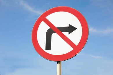 Photo of Road sign No Right Turn against blue sky outdoors