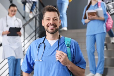 Photo of Portrait of medical student with stethoscope on staircase in college, space for text