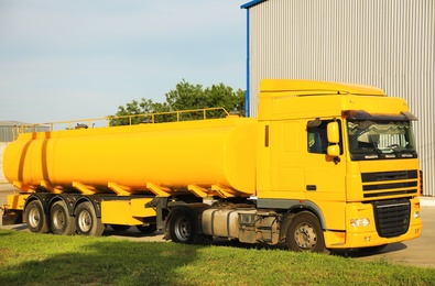 Modern yellow truck parked on country road