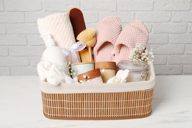 Spa gift set in wicker basket on white marble table