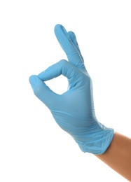Person in blue latex gloves showing okay gesture against white background, closeup on hand
