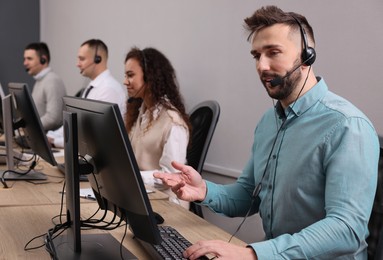 Photo of Call center operators working in modern office
