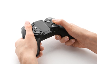 Young woman holding video game controller on white background, closeup
