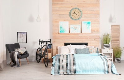 Modern apartment interior with bicycle near bed