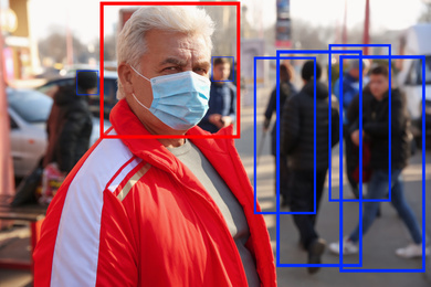 Senior man with medical mask and scanner frame on city street. Machine learning