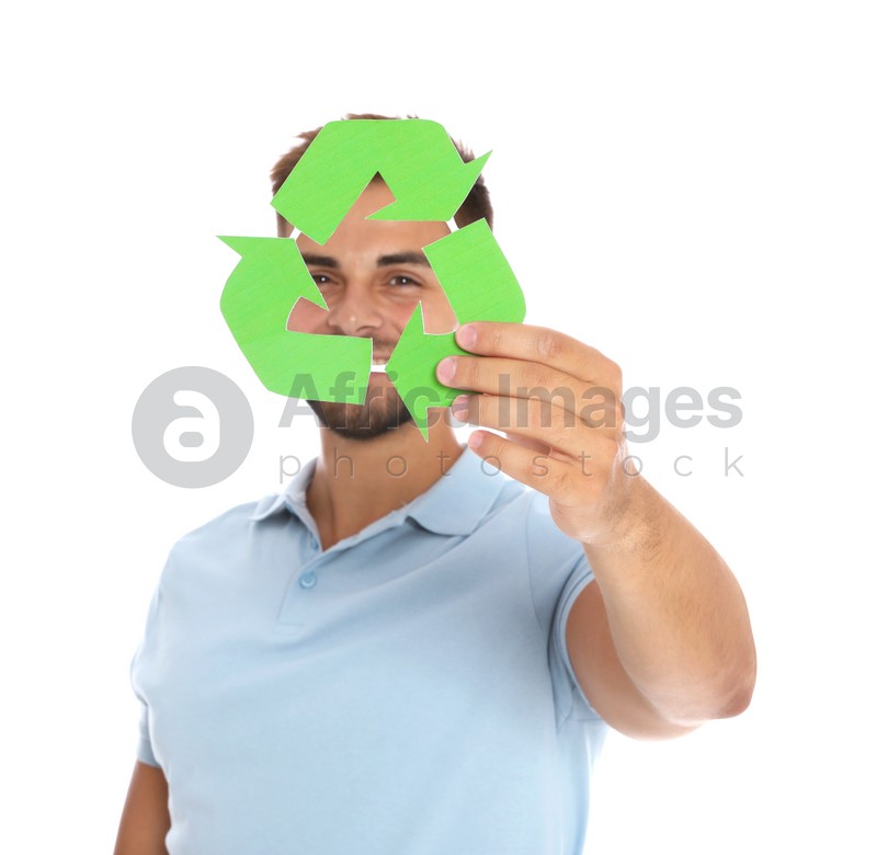 Young man with recycling symbol on white background