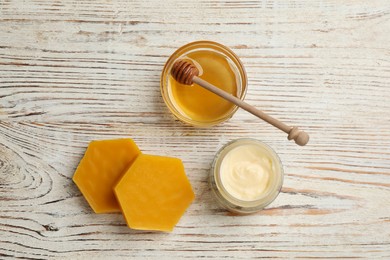 Natural beeswax, cream and honey on white wooden table, flat lay