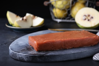 Delicious quince paste served on black table