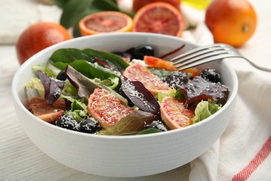 Bowl of delicious sicilian orange salad on white wooden table, closeup