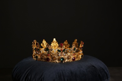 Beautiful golden crown on black velvet pillow. Fantasy item