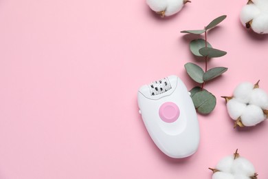 Photo of Modern epilator, fluffy cotton flowers and eucalyptus branch on pink background, flat lay. Space for text