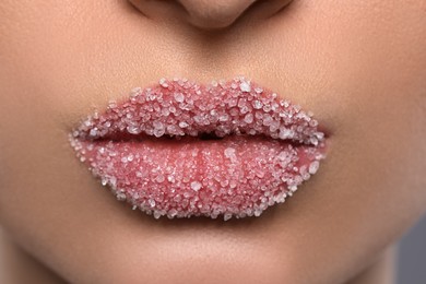 Woman with beautiful plump lips covered in sugar, closeup