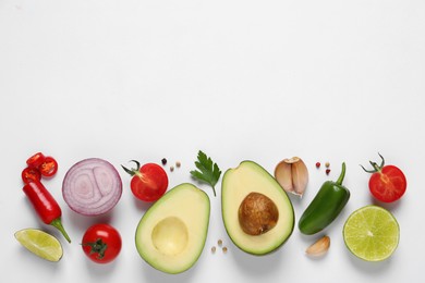 Fresh ingredients for guacamole on white background, flat lay