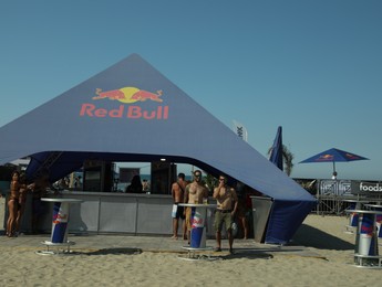 Photo of SENIGALLIA, ITALY - JULY 22, 2022: Red Bull tent on beach under blue sky