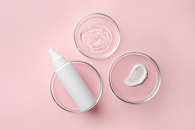 Photo of Petri dishes and cosmetic products on pink background, flat lay
