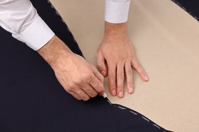 Photo of Dressmaker marking fabric with chalk, closeup view
