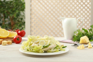 Photo of Delicious salad with Chinese cabbage, eggs and meat served on white wooden table