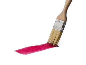 Photo of Crimson paint stroke and brush on white background