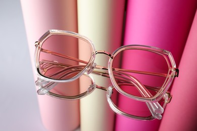 Stylish sunglasses on glass table. Fashionable accessory