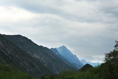 Picturesque landscape with high mountains under gloomy sky outdoors