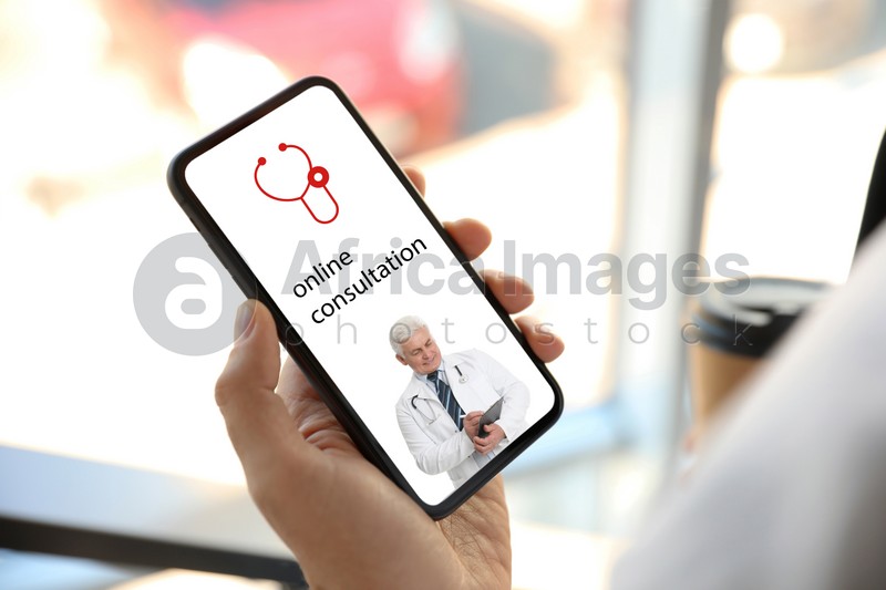 Image of Man using smartphone for online consultation with doctor via video chat, closeup