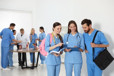 Photo of Medical students wearing uniforms in university hallway