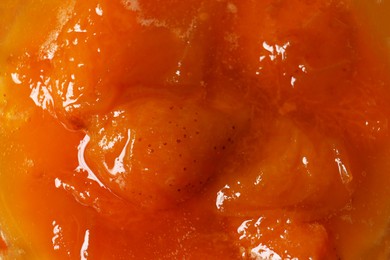 Delicious apricot jam as background, closeup view
