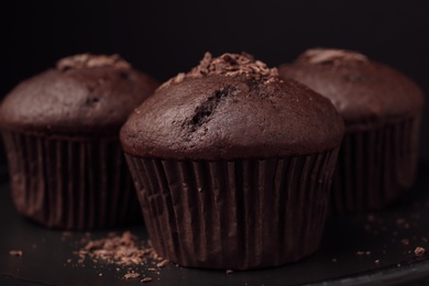 Delicious cupcakes with chocolate crumbles on black table, closeup