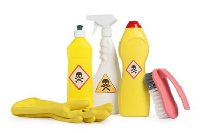 Photo of Bottles of toxic household chemicals with warning signs, gloves and brush on white background