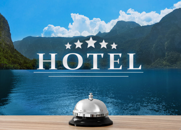 Image of 5 Star hotel. Reception desk with service bell and picturesque landscape on background