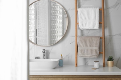 Photo of Decorative ladder near vessel sink in stylish bathroom. Idea for interior design