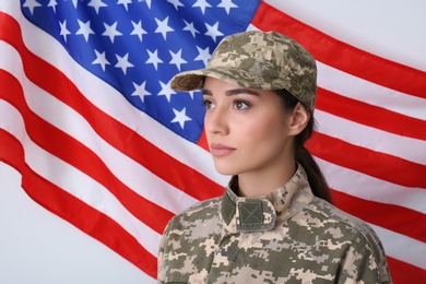 Female soldier in uniform and United states of America flag on white background