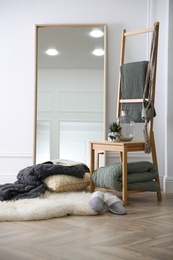 Comfortable place for rest with soft blankets and large mirror