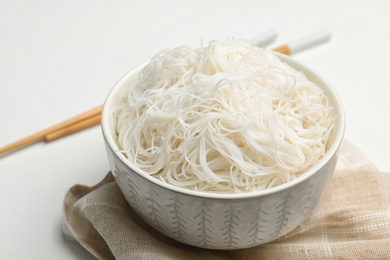 Tasty cooked rice noodles on white table, closeup