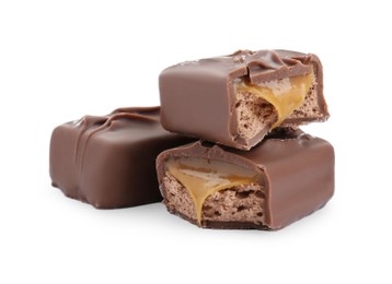 Photo of Pieces of chocolate bars with caramel on white background