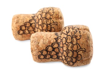Two sparkling wine corks with grape images on white background