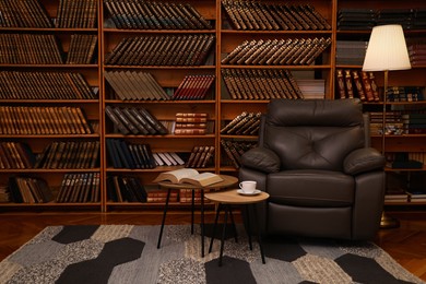 Cozy home library interior with leather armchair and collection of vintage books on shelves