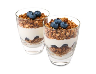 Glasses of tasty yogurt with muesli and blueberries isolated on white