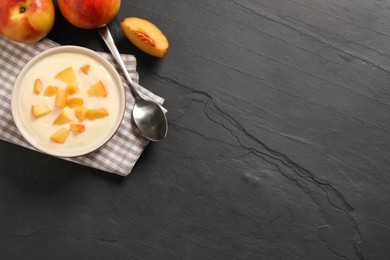 Delicious yogurt with fresh peach on black table, flat lay. Space for text