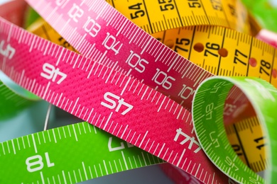 Kit of different measuring tapes as background, closeup