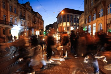 Photo of People crossing city street at night, long exposure effect