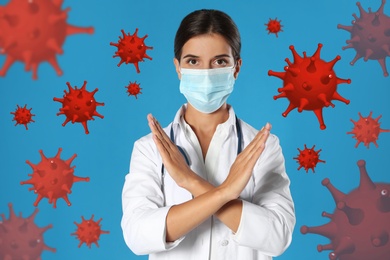 Stop Covid-19 outbreak. Doctor wearing medical mask surrounded by virus on blue background