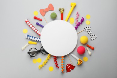 Flat lay composition with carnival items and blank card on light grey background. Space for text