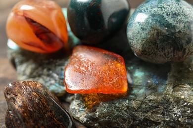 Photo of Different beautiful gemstones on table, closeup view