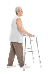 Full length portrait of elderly woman using walking frame isolated on white
