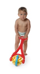 Cute baby with push toy learning to walk on white background