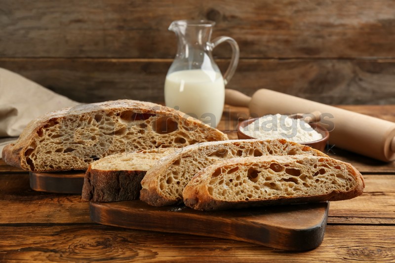 Tasty freshly baked bread on wooden table