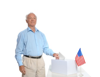 Elderly man putting ballot paper into box against white background
