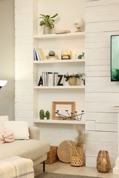 Shelves with different decor in room. Interior design