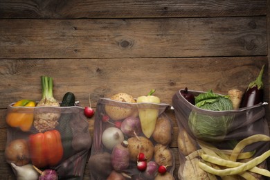 Photo of Different fresh ripe vegetables on wooden table, flat lay. Space for text